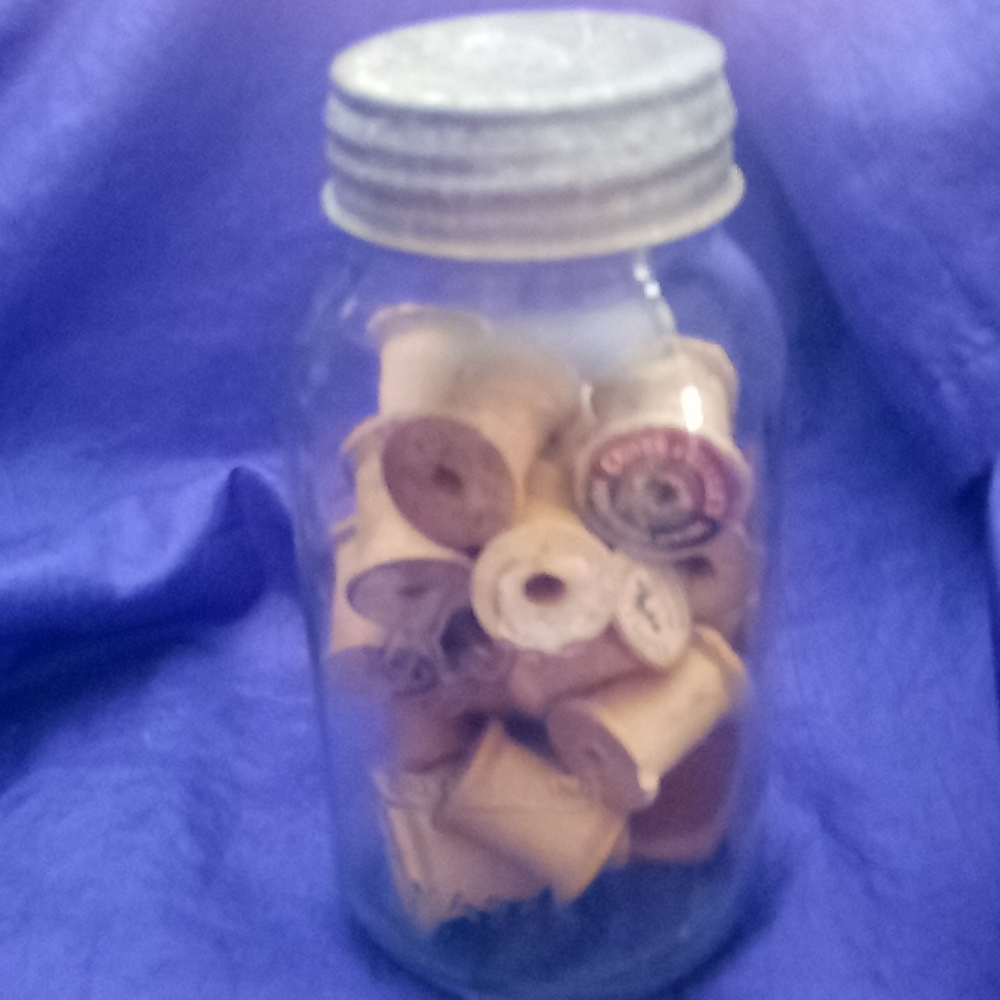 Vintage kerr Mason jar with 25 vintage wooden thread spools